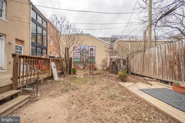 a view of a yard with wooden fence