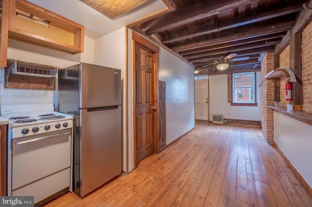 a view of a refrigerator in kitchen and wooden floor