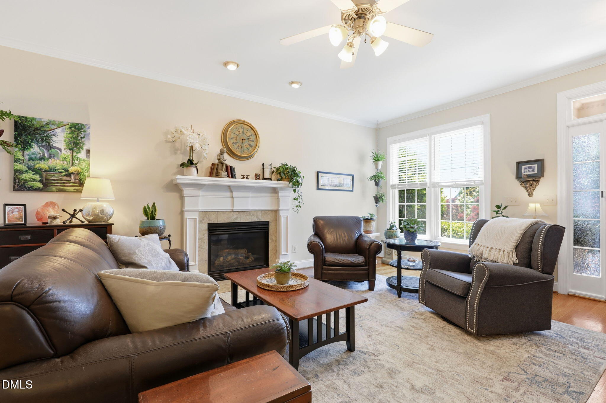 7040 Dayton Ridge Drive Apex, NC 27539 - Photo 2 of 38 a living room with furniture a fireplace and a large window