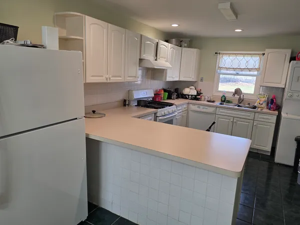 a kitchen with stainless steel appliances a refrigerator sink and cabinets