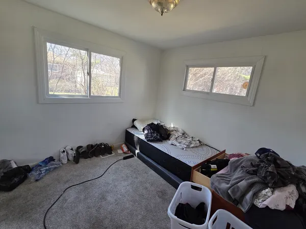 a bedroom with a bed and a window