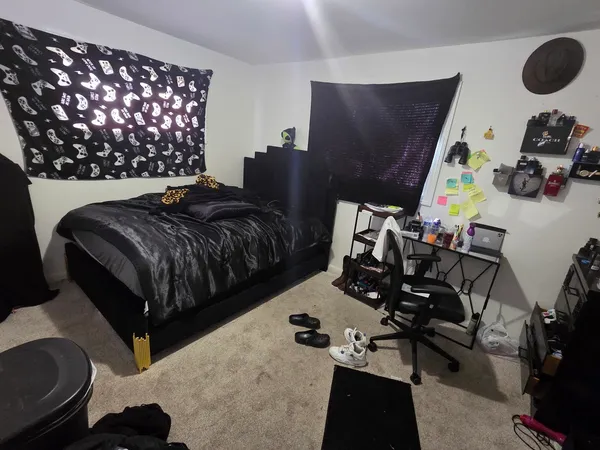 a bedroom with bed and a window