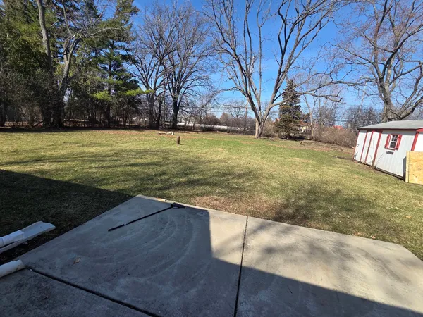 a view of yard with swimming pool and green space