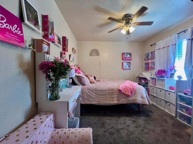 a bed room with a bed mirror and a window