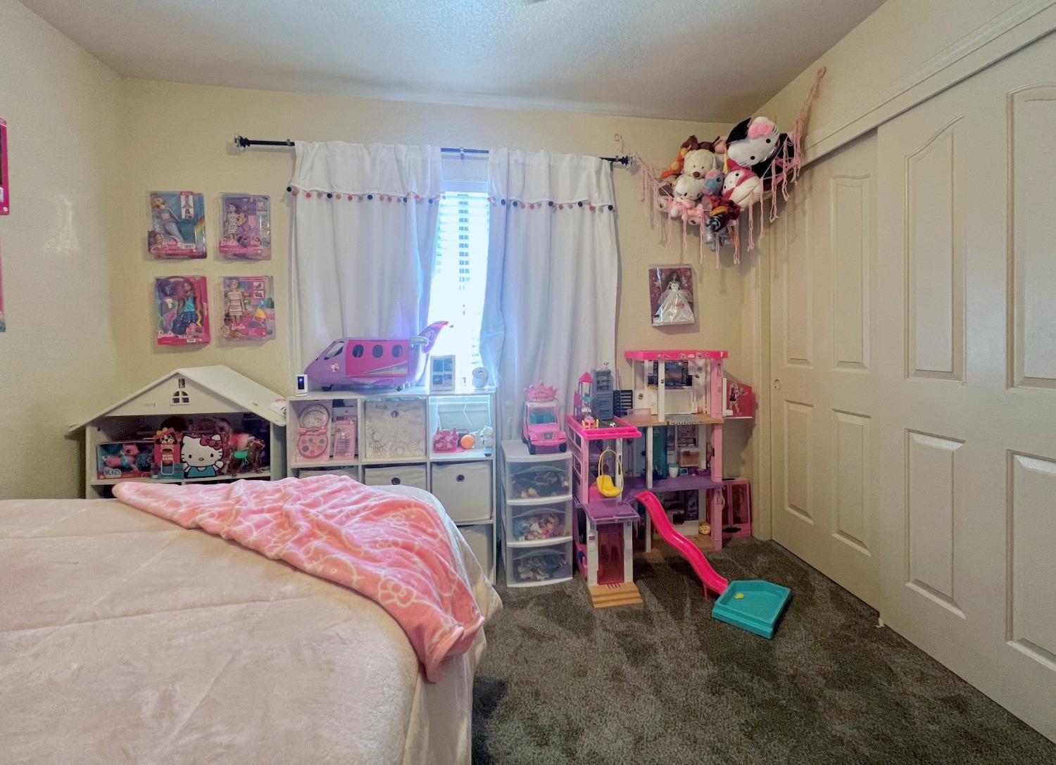 3116 Larrynell Drive Ceres, CA 95307 - Photo 15 of 32 a bed room with a bed and a desk