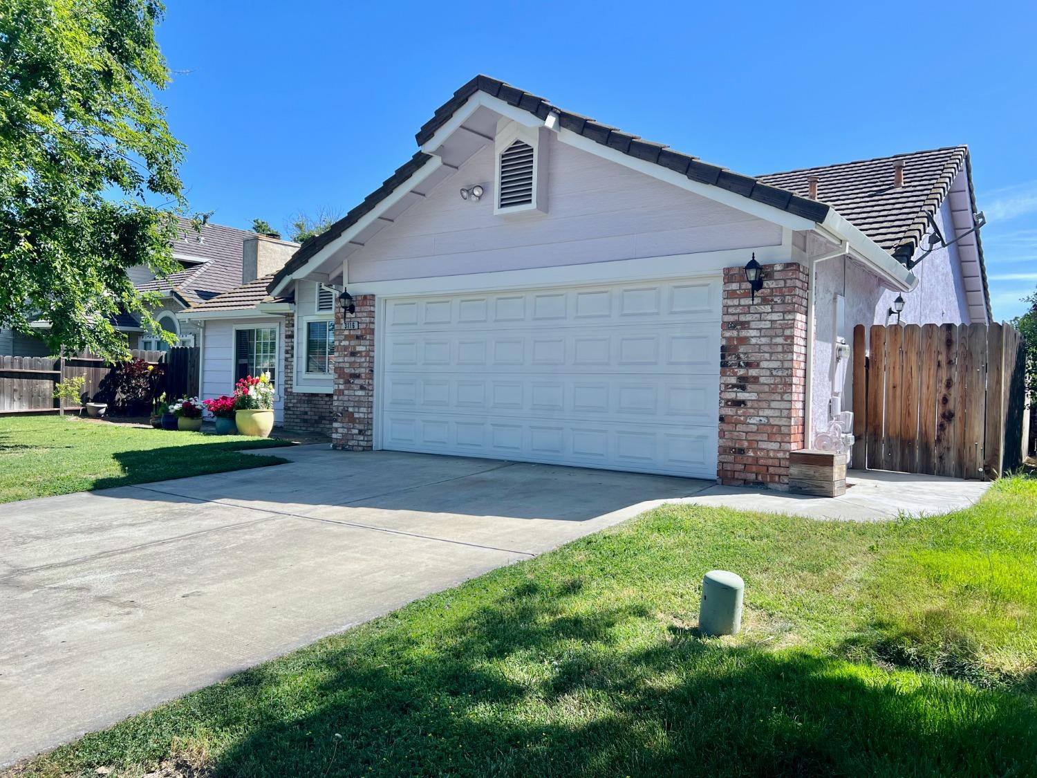3116 Larrynell Drive Ceres, CA 95307 - Photo 2 of 32 a front view of a house with a yard and garage