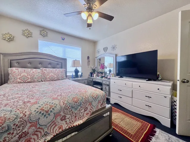 a bedroom with a bed and flat screen tv