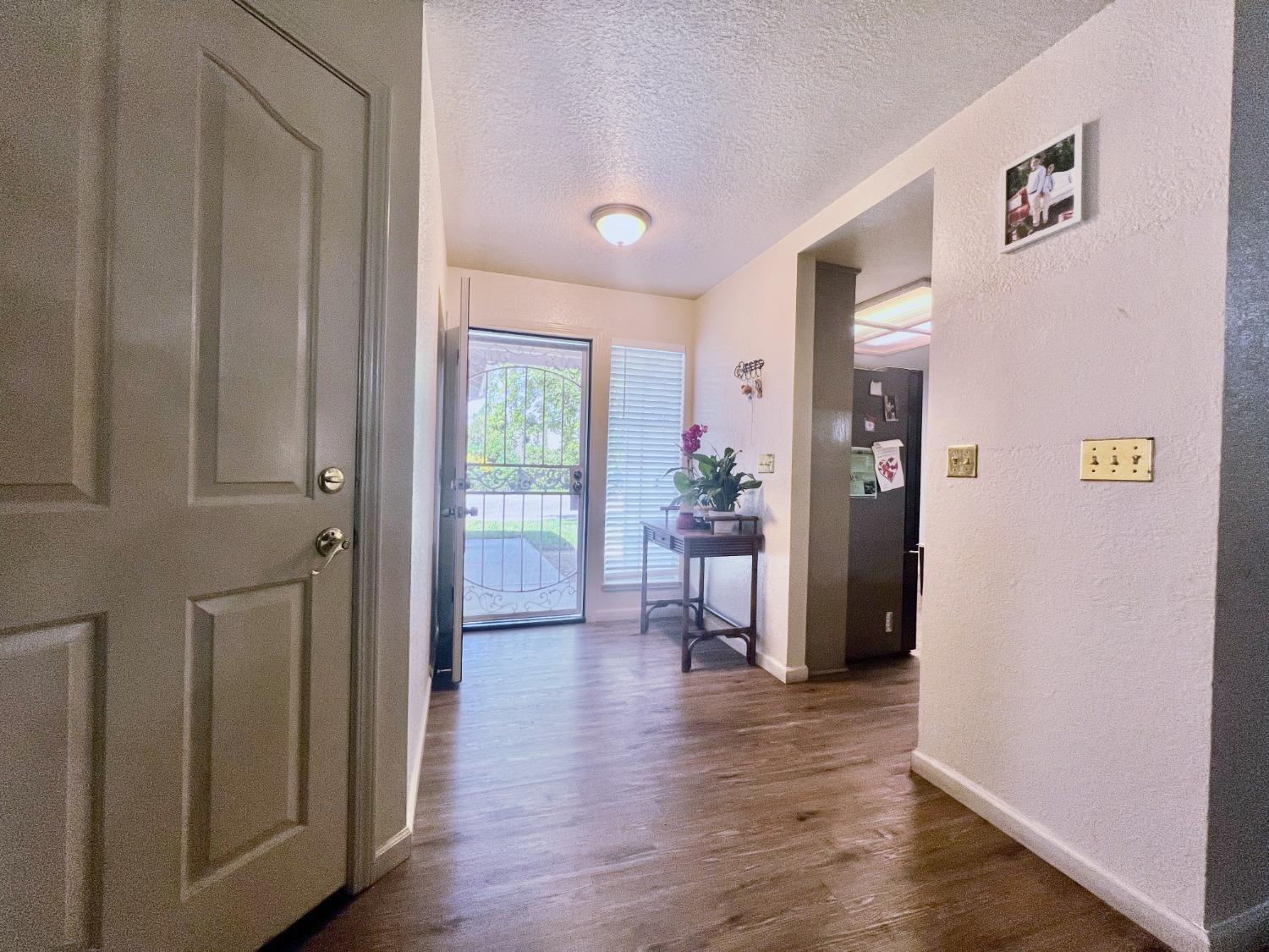 3116 Larrynell Drive Ceres, CA 95307 - Photo 23 of 32 a view of a hallway with bathroom and wooden floor