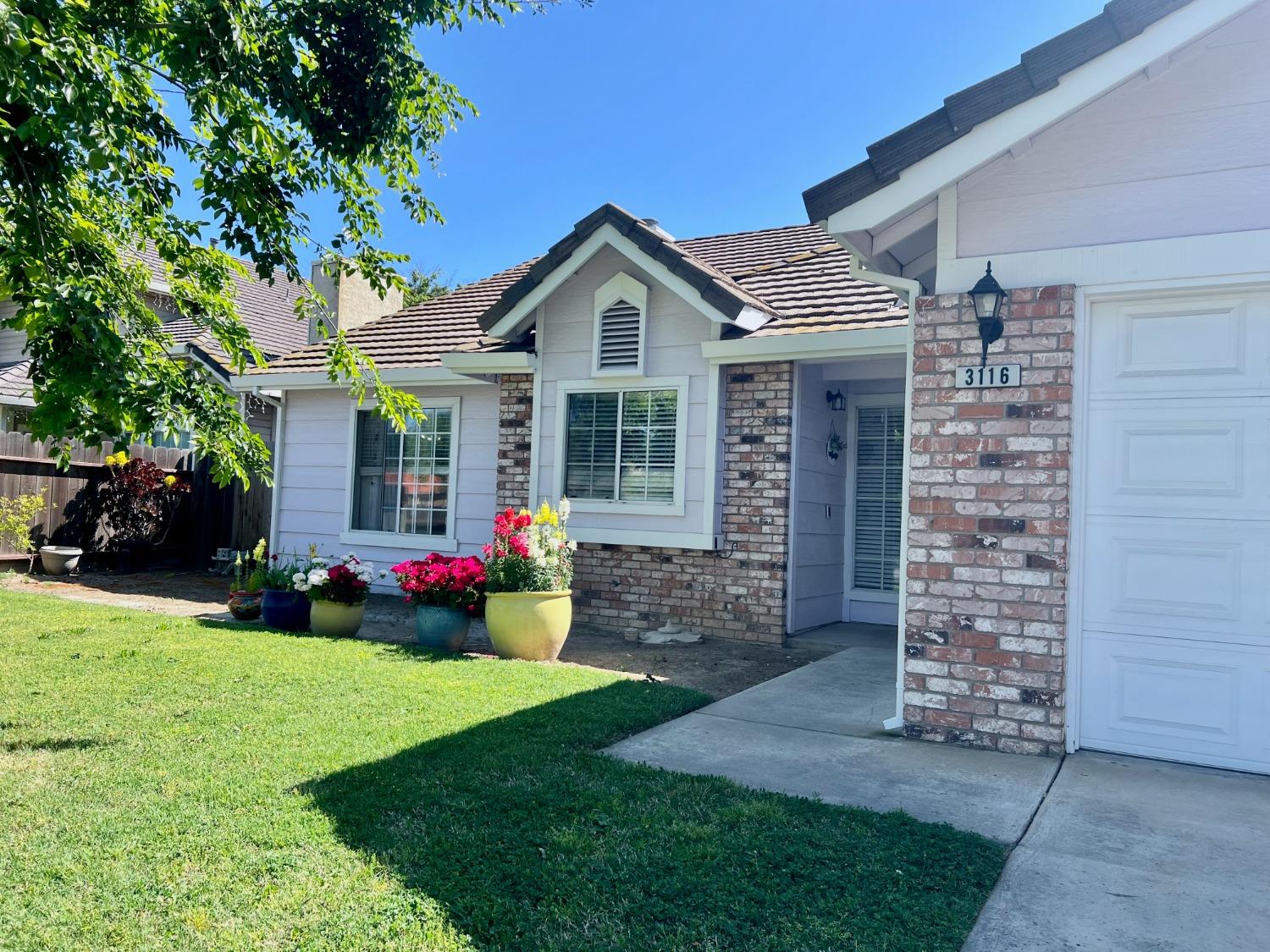 3116 Larrynell Drive Ceres, CA 95307 - Photo 3 of 32 a front view of a house with a yard and garage