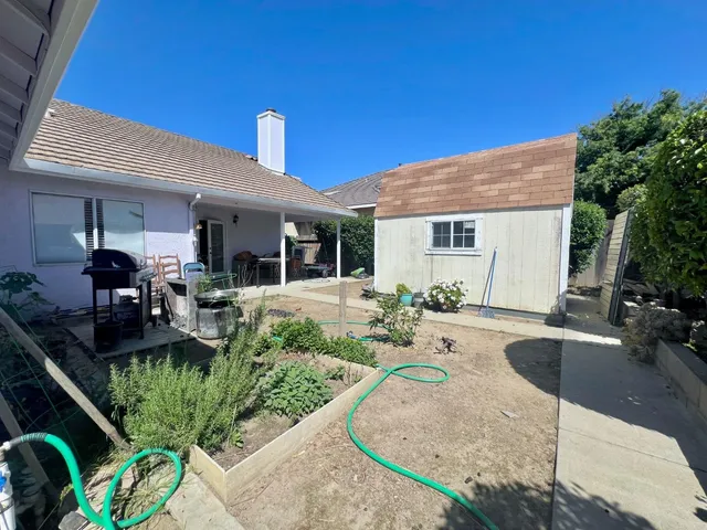 a view of a house with backyard patio and swimming pool