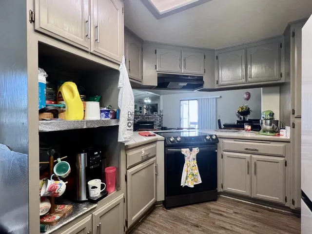 a kitchen with stainless steel appliances granite countertop a stove a sink and cabinets