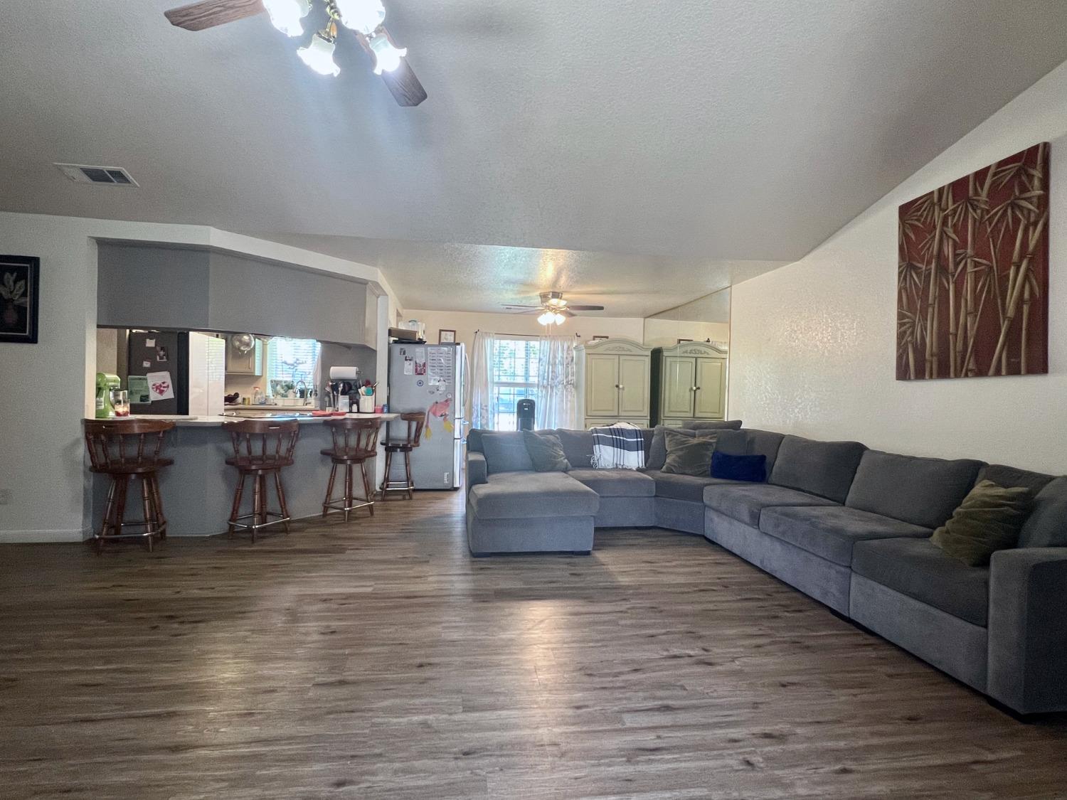 3116 Larrynell Drive Ceres, CA 95307 - Photo 8 of 32 a living room with furniture and a large mirror with wooden floor