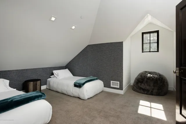 a bedroom with bed and a couch