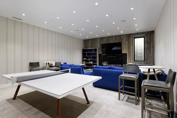 a living room with furniture a flat screen tv and a rug