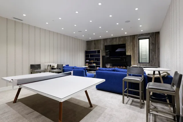 a living room with furniture a flat screen tv and a rug