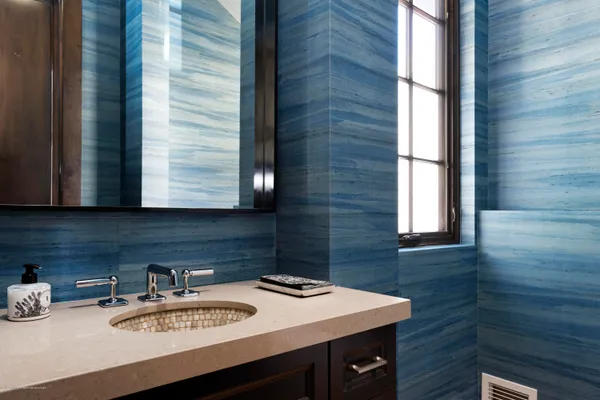 a bathroom with a sink a vanity and a window