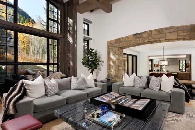 a living room with furniture and a floor to ceiling window