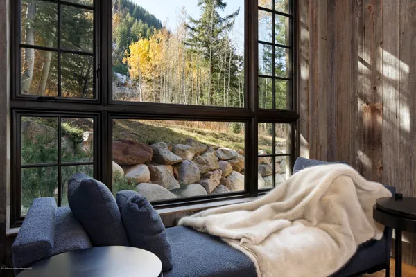 a balcony with furniture and a large window