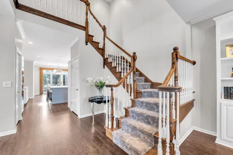 a view of entryway and hall with wooden floor