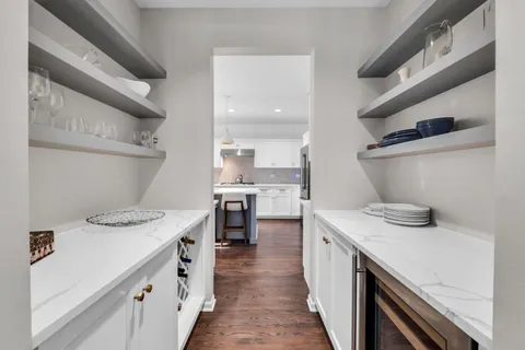 a kitchen with a sink a stove and cabinets