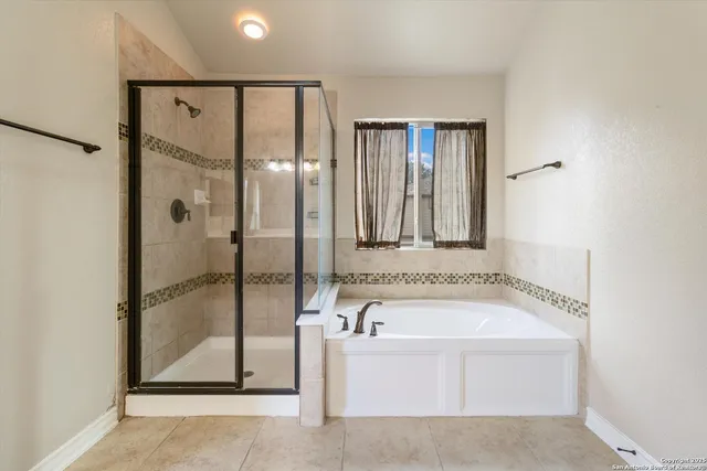 a bathroom with a bathtub and a shower