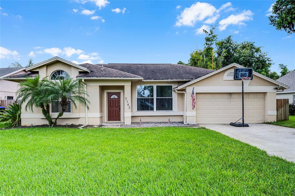 5142 Coddington Street Orlando, FL 32812 - Photo 1 of 1 a front view of house with a garden