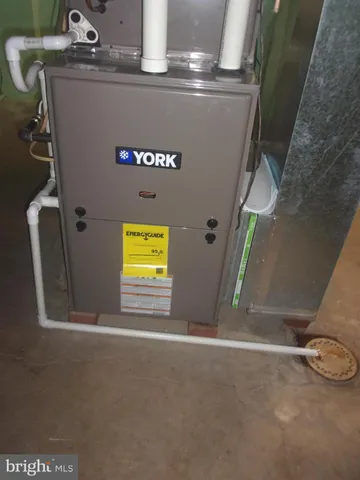 a view of a house with large windows and a small yard