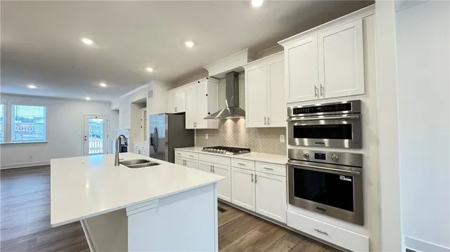 a kitchen with a sink a stove and refrigerator