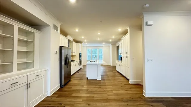 a view of a hallway with wooden floor