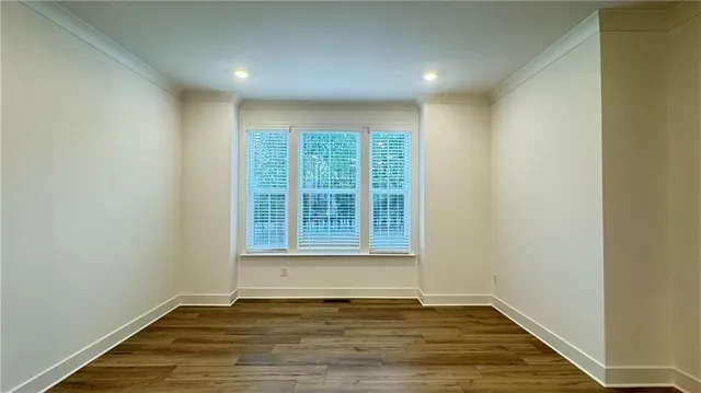 a living room with a fireplace cabinet and a wooden floor