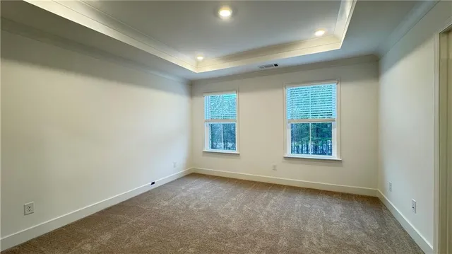 an empty room with closet and wooden door