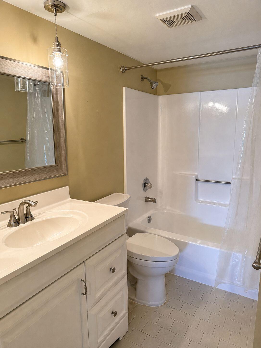 1871 Southwest Palm City Road, Unit G401 Stuart, FL 34994 - Photo 8 of 16 a bathroom with a sink toilet and shower