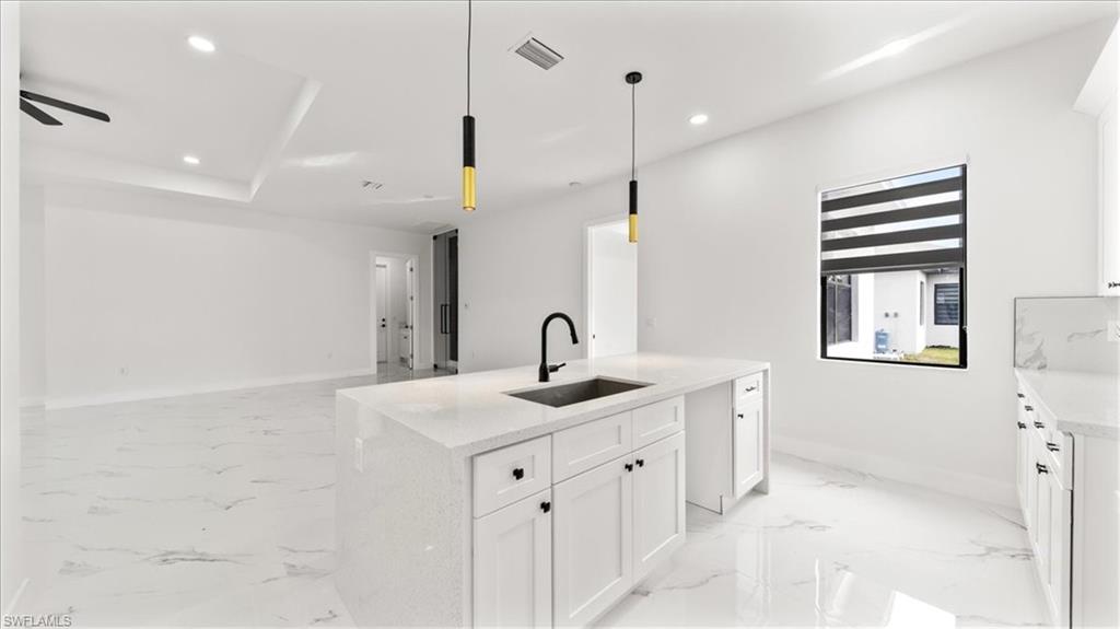 766 Roma Avenue South Lehigh Acres, FL 33974 - Photo 13 of 50 a bathroom with a sink a toilet and a mirror