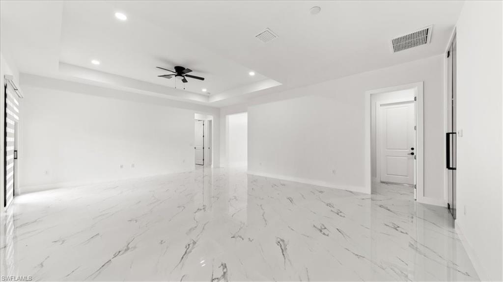 766 Roma Avenue South Lehigh Acres, FL 33974 - Photo 17 of 50 wooden floor in an empty room with a window