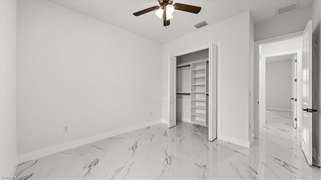 766 Roma Avenue South Lehigh Acres, FL 33974 - Photo 26 of 50 an empty room with a ceiling fan