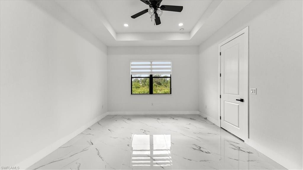 766 Roma Avenue South Lehigh Acres, FL 33974 - Photo 28 of 50 an empty room with windows and ceiling fan
