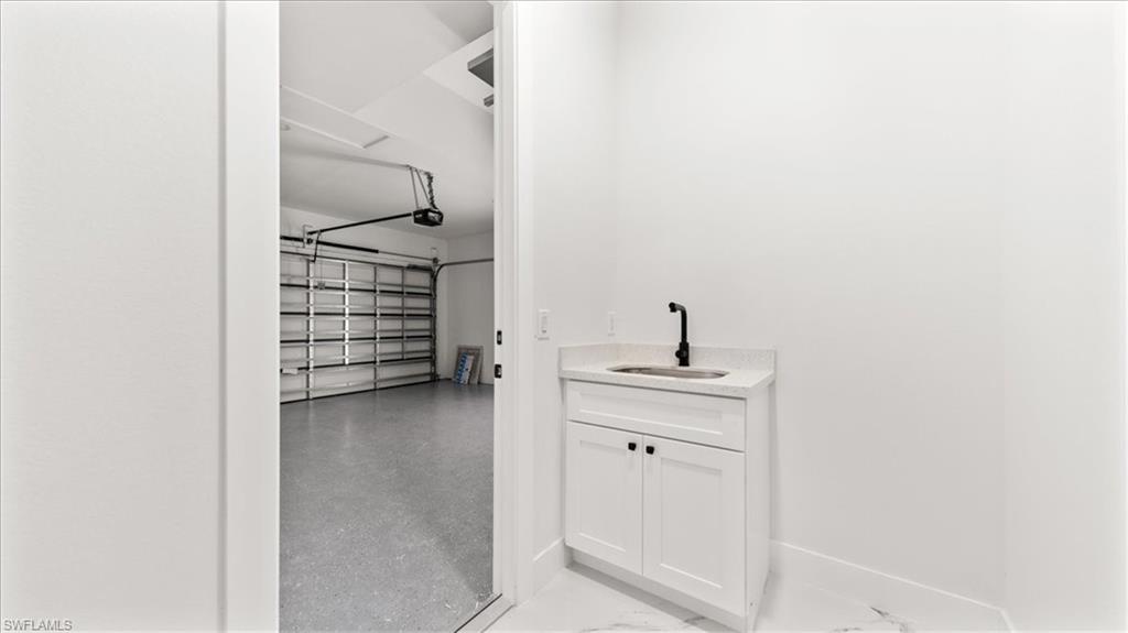 766 Roma Avenue South Lehigh Acres, FL 33974 - Photo 31 of 50 a bathroom with a sink and a mirror