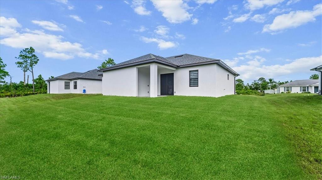 766 Roma Avenue South Lehigh Acres, FL 33974 - Photo 35 of 50 a front view of house with yard and green space