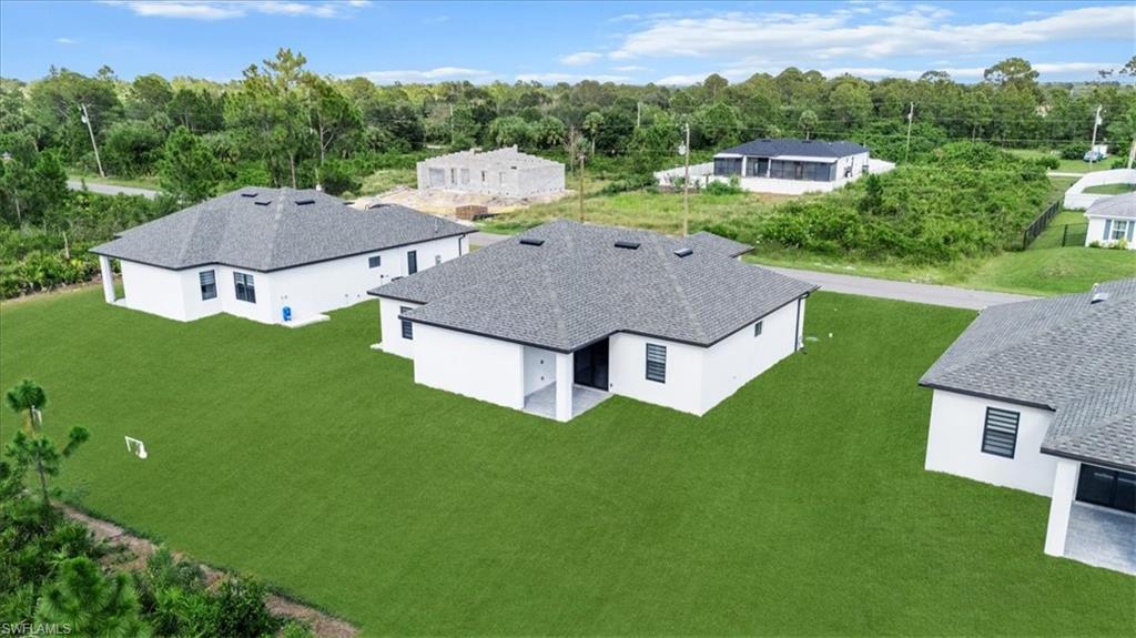 766 Roma Avenue South Lehigh Acres, FL 33974 - Photo 40 of 50 an aerial view of a house with a garden
