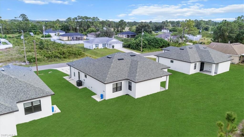 766 Roma Avenue South Lehigh Acres, FL 33974 - Photo 41 of 50 an aerial view of residential houses with outdoor space and trees