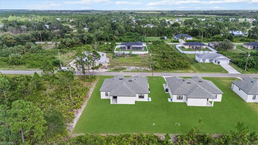766 Roma Avenue South Lehigh Acres, FL 33974 - Photo 44 of 50 an aerial view of residential houses with outdoor space and city view
