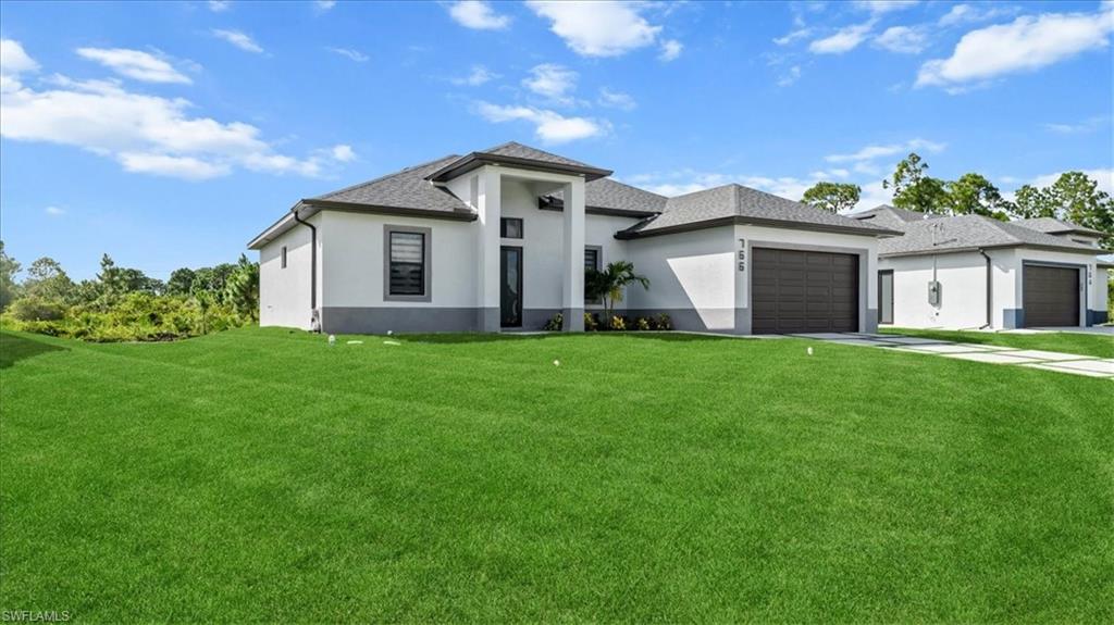 766 Roma Avenue South Lehigh Acres, FL 33974 - Photo 6 of 50 a front view of house with yard and green space