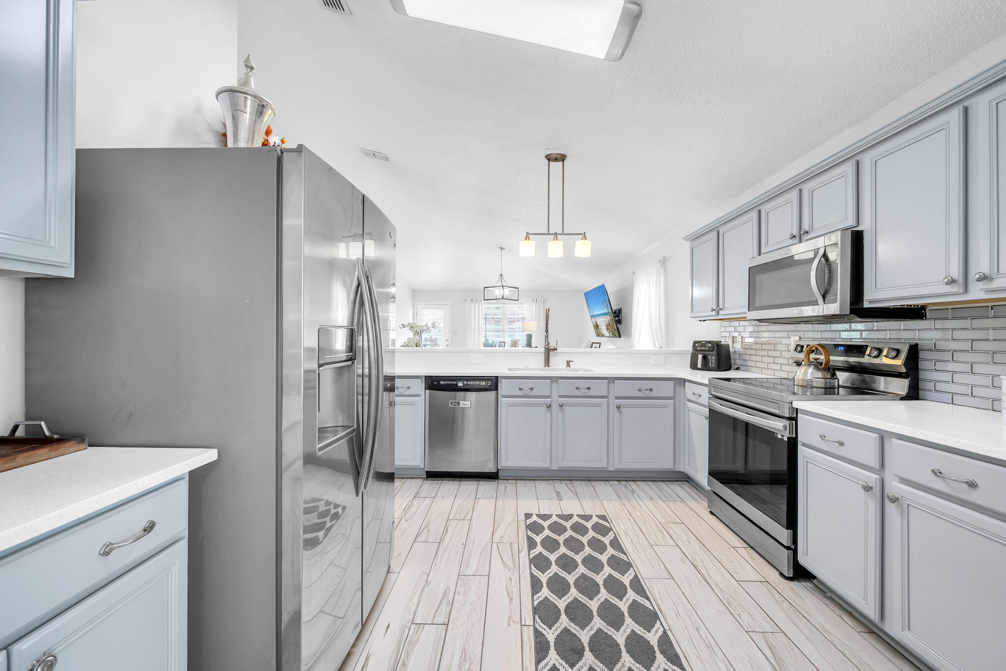 119 Red Bay Court Santa Rosa Beach, FL 32459 - Photo 17 of 36 a kitchen with a sink a counter top space stainless steel appliances and cabinets