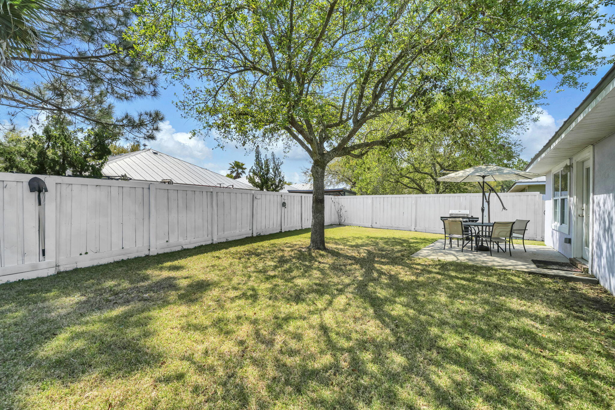 119 Red Bay Court Santa Rosa Beach, FL 32459 - Photo 32 of 36 a view of a backyard with wooden fence and a large tree