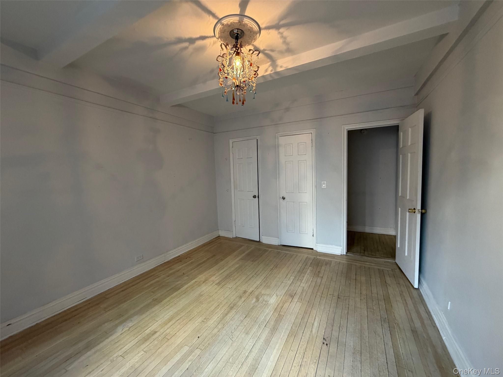 142 East 49th Street, Unit 8A Manhattan, NY 10017 - Photo 8 of 12 a view of an empty room with wooden floor