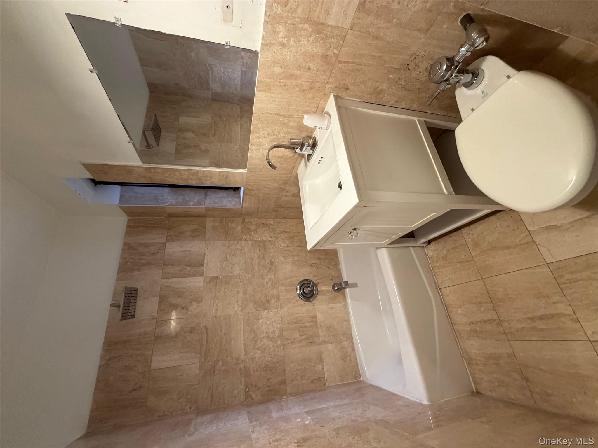 142 East 49th Street, Unit 8A Manhattan, NY 10017 - Photo 9 of 12 a bathroom with a sink a toilet and bathtub