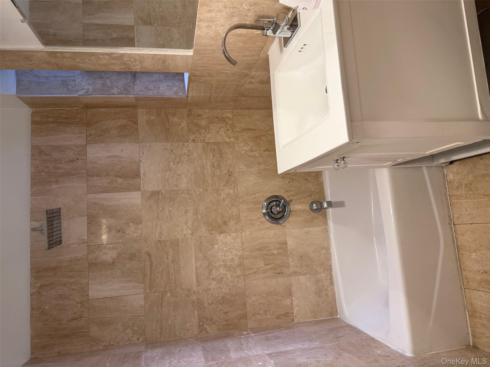 142 East 49th Street, Unit 8A Manhattan, NY 10017 - Photo 10 of 12 a bathroom with a sink and a bathtub