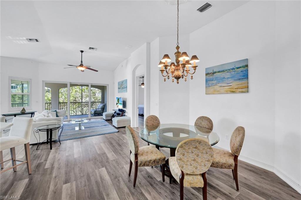 1277 Rialto Way, Unit 201 Naples, FL 34114 - Photo 12 of 46 a living room with furniture and a chandelier