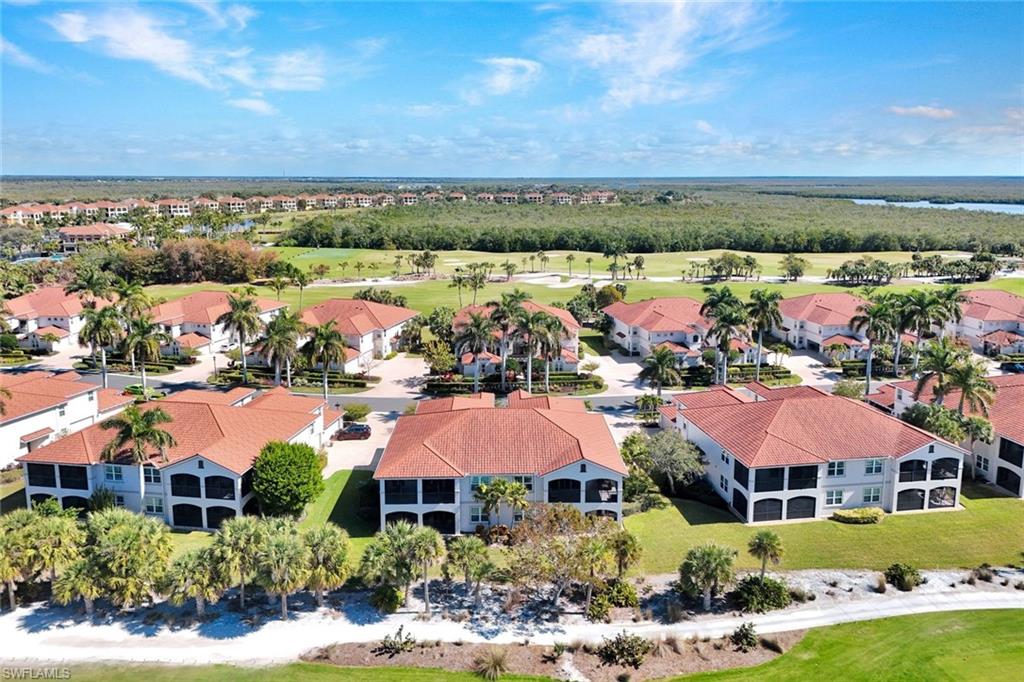 1277 Rialto Way, Unit 201 Naples, FL 34114 - Photo 29 of 46 an aerial view of house with yard swimming pool and outdoor seating