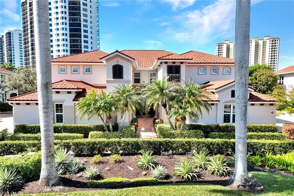 a aerial view of a white house with a yard and plants